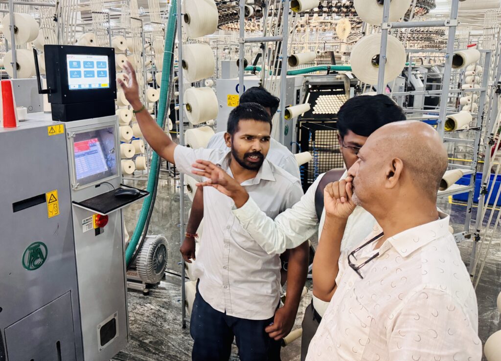Indo Texnology team demonstrating the Knit i real-time AI fabric inspection system on a circular knitting machine during a post-installation visit at a textile mill